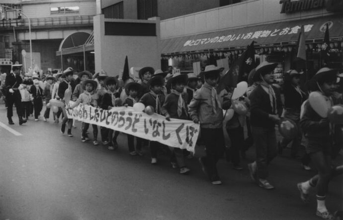 写真：たれ幕を持って行進する交通少年団