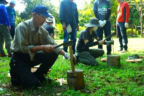 写真：ナタで薪割りをする様子